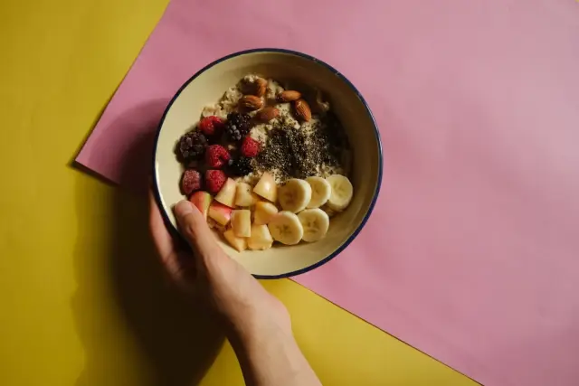 An oatmeal bowl with fruit and nuts.