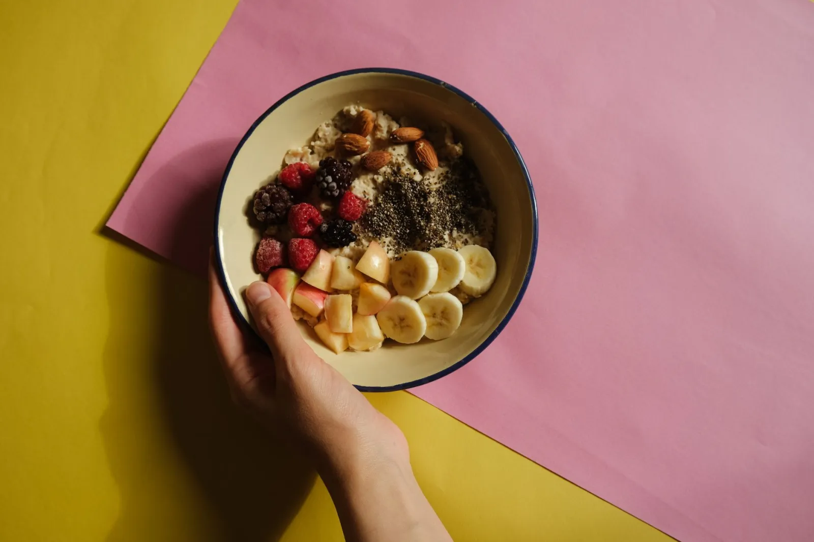 An oatmeal bowl with fruit and nuts.