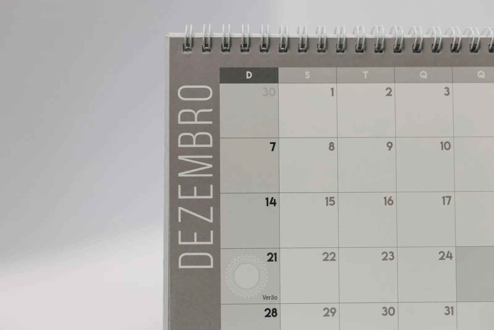 A simple December calendar page on a plain surface in flat daylight.