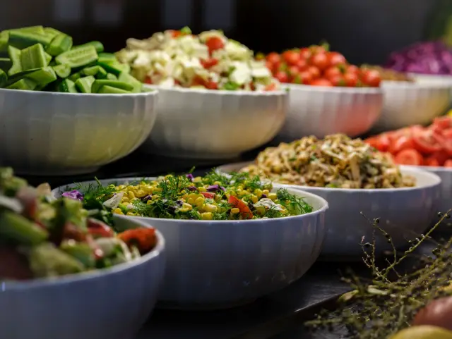 A large bowl of colourful salad vegetables on a kitchen counter.