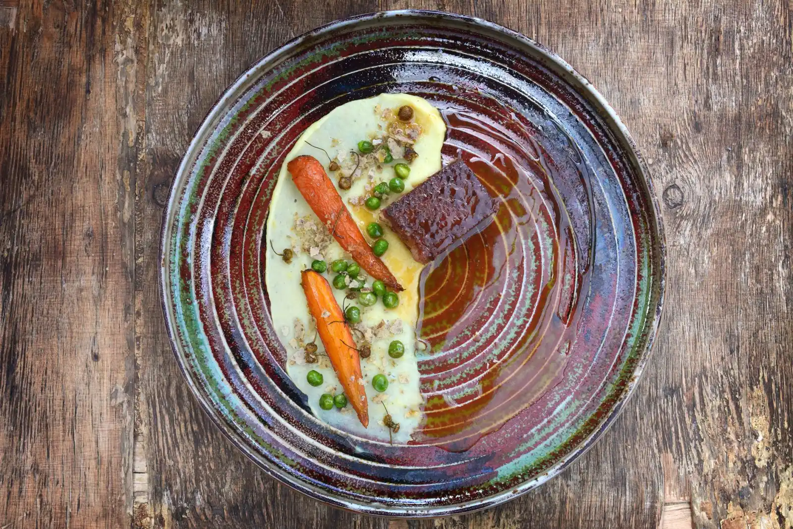 A single plated dish with a modest portion of vegetables on a rustic wooden table.